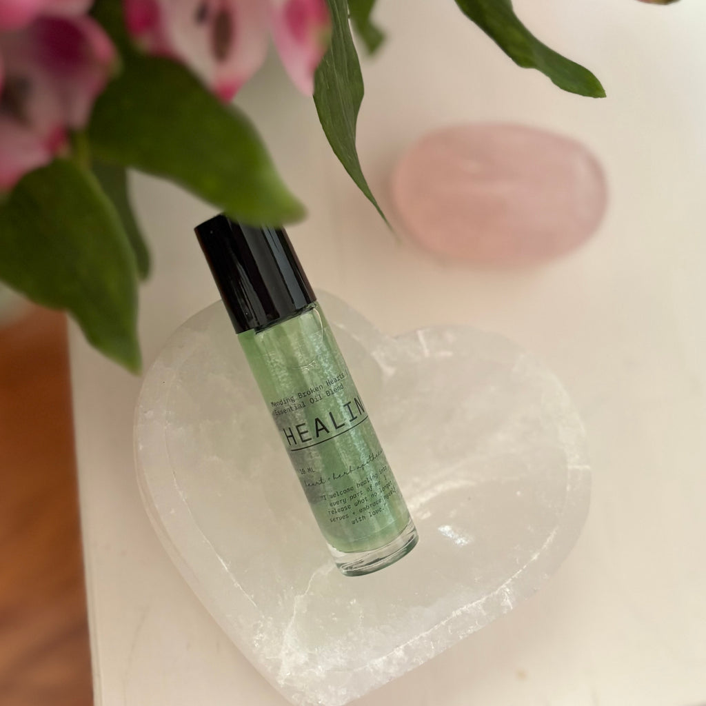 Green bottle labeled 'HEALTH' on a white surface with pink flowers in the background