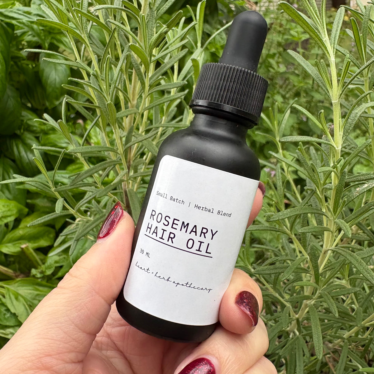 Bottle of rosemary-infused olive hair oil by Heart + Herb Apothecary